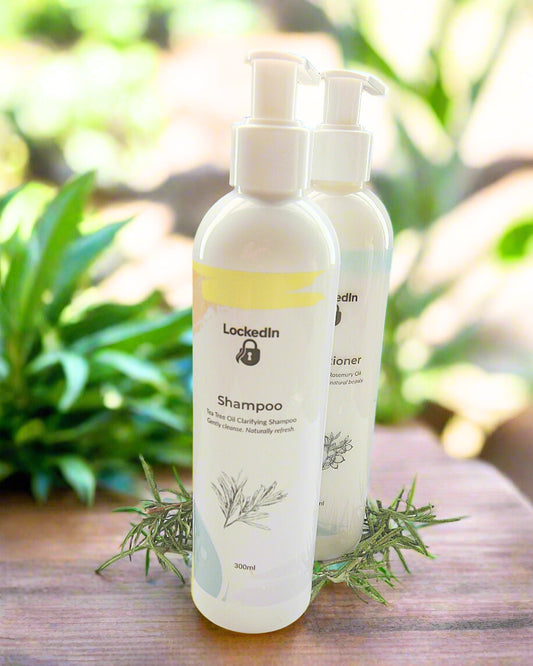 Two bottles of 'Lockedin' shampoo on a wooden surface with greenery in the background.