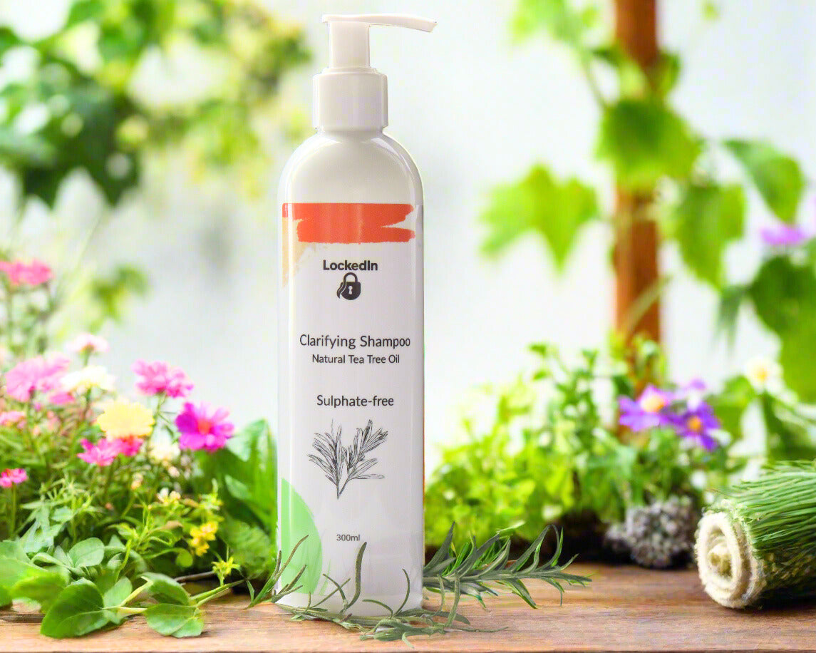 Clarifying shampoo bottle with natural tea tree oil on a wooden surface with greenery