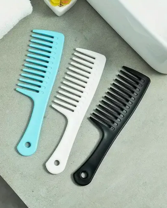 Three combs in blue, white, and black on a gray surface.